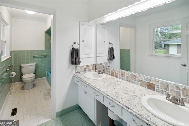 bathroom featuring tile patterned flooring, vanity, toilet, and ornamental molding