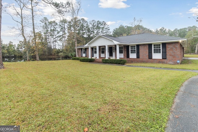 ranch-style house with a front lawn and covered porch