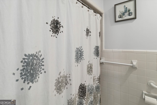 bathroom with tile walls