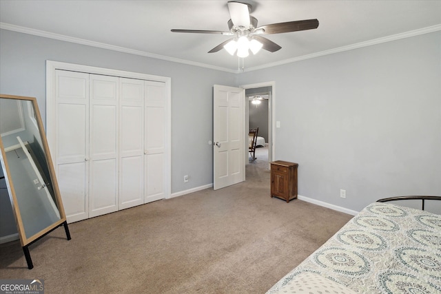 bedroom with ceiling fan, light colored carpet, ornamental molding, and a closet