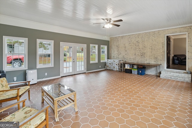 unfurnished living room with french doors, plenty of natural light, ornamental molding, and ceiling fan