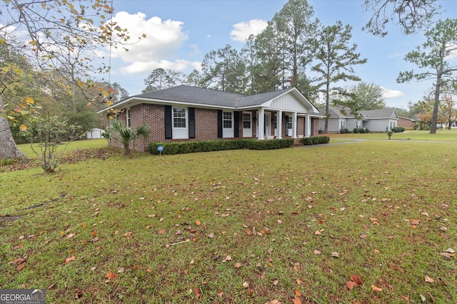 single story home featuring a porch and a front yard