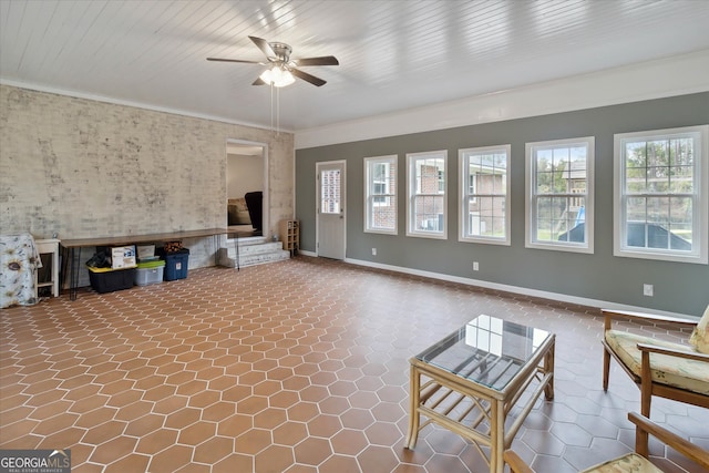 unfurnished living room featuring ceiling fan and ornamental molding