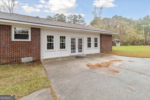 exterior space featuring french doors, a patio, and a lawn