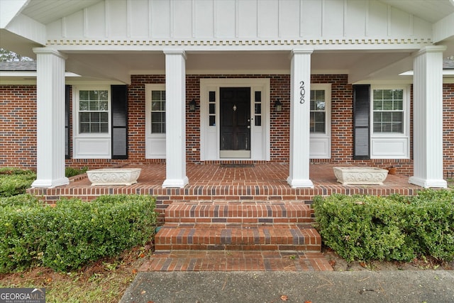 entrance to property featuring a porch