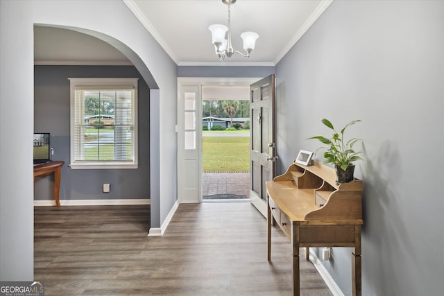 entryway with dark hardwood / wood-style flooring, crown molding, and a notable chandelier