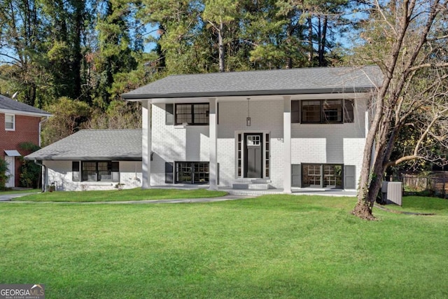 bi-level home with central air condition unit and a front yard