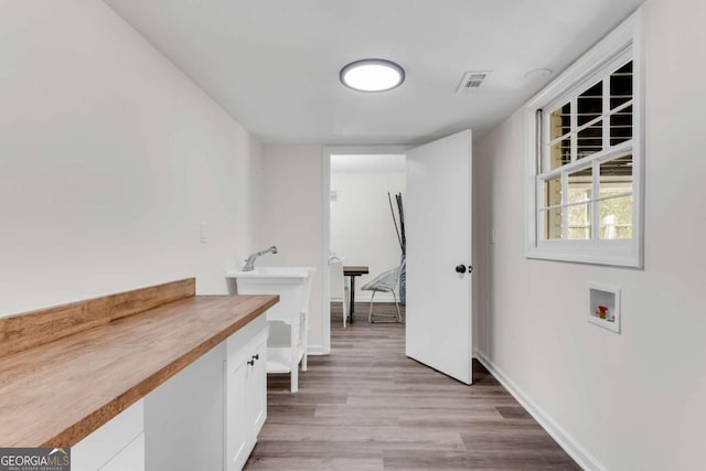 laundry area featuring washer hookup and light hardwood / wood-style flooring