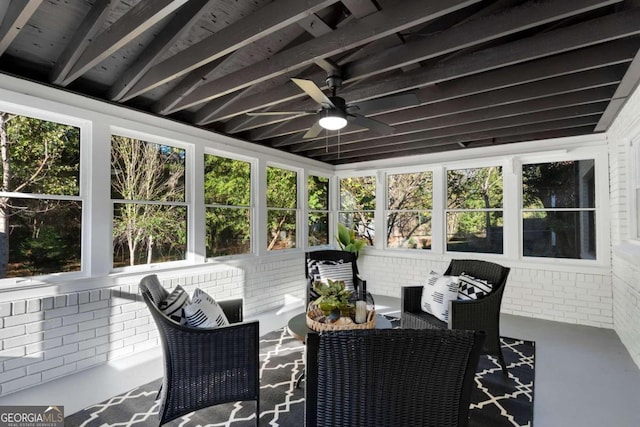 sunroom with ceiling fan and lofted ceiling