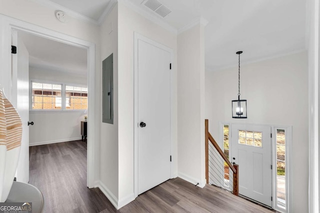 foyer entrance featuring wood-type flooring, crown molding, and electric panel