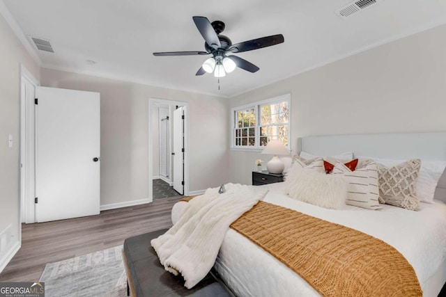 bedroom with ceiling fan and wood-type flooring