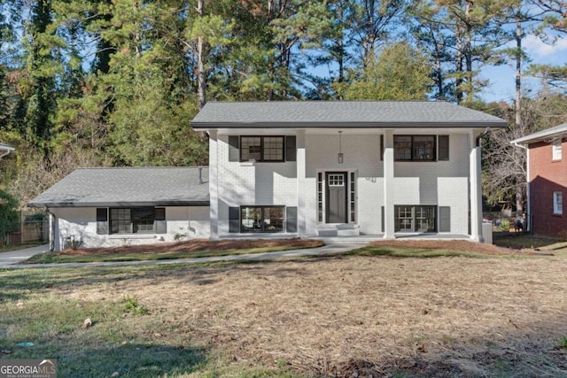 raised ranch featuring a front lawn