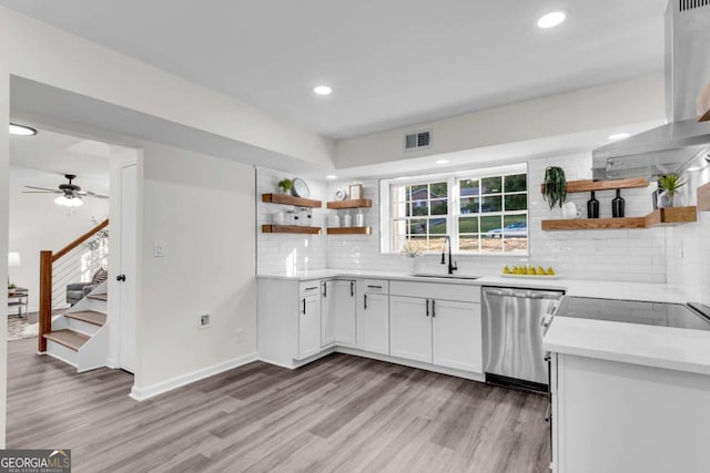 kitchen with sink, stainless steel dishwasher, ceiling fan, light wood-type flooring, and white cabinetry