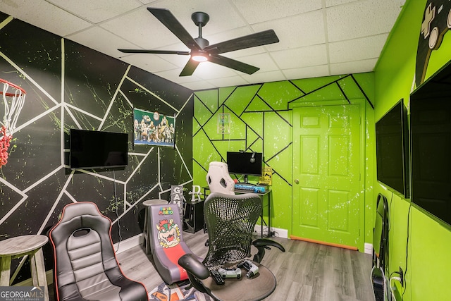 office space with hardwood / wood-style floors, ceiling fan, and a drop ceiling