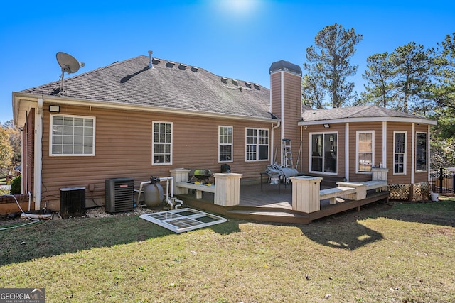 back of house with a yard, cooling unit, and a wooden deck