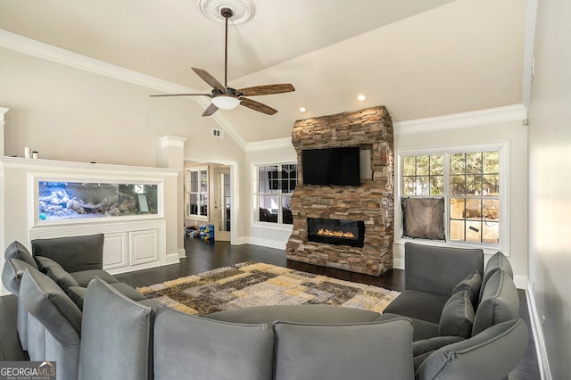 living room with lofted ceiling, a stone fireplace, crown molding, dark hardwood / wood-style floors, and ceiling fan