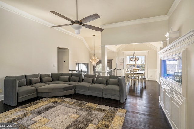 living room with ceiling fan with notable chandelier, dark hardwood / wood-style flooring, decorative columns, and ornamental molding