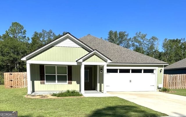 view of front of house featuring a front lawn and a garage