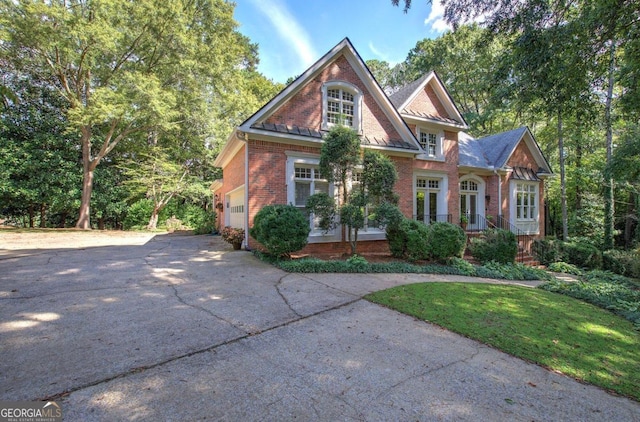 view of front facade with a garage and a front lawn