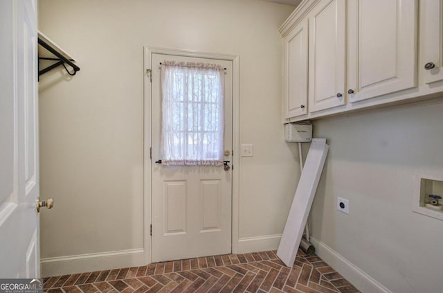 clothes washing area featuring hookup for an electric dryer, washer hookup, and cabinets