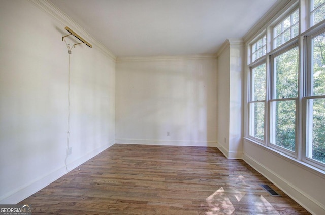 unfurnished room featuring crown molding and dark hardwood / wood-style flooring