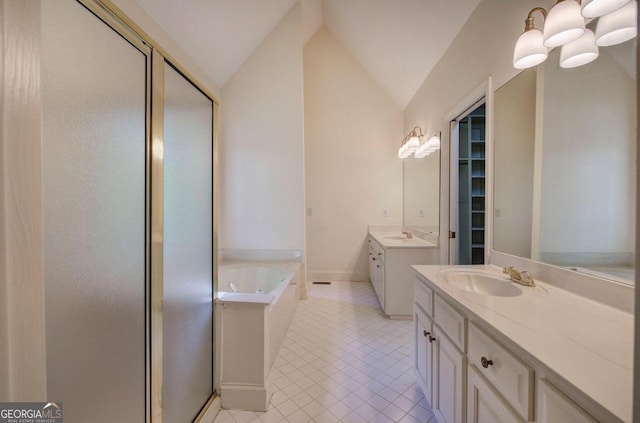 bathroom with tile patterned floors, vanity, vaulted ceiling, and independent shower and bath