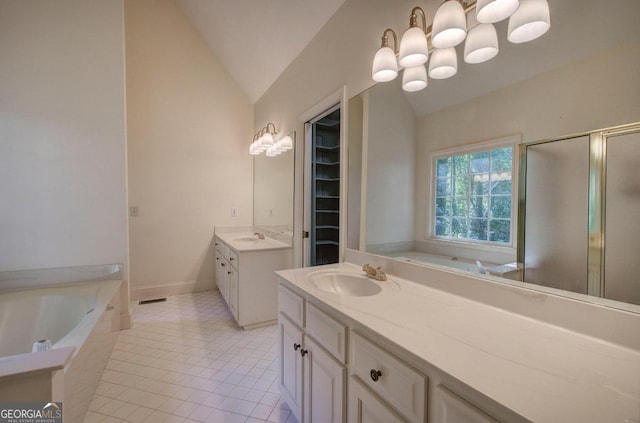 bathroom featuring separate shower and tub, tile patterned floors, vanity, and vaulted ceiling