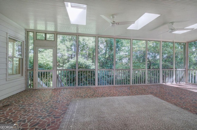 unfurnished sunroom with ceiling fan