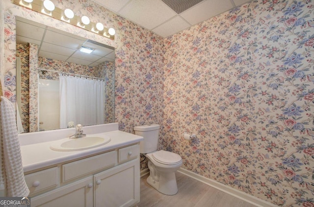 bathroom featuring vanity, wood-type flooring, a paneled ceiling, and walk in shower