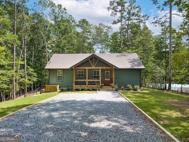 view of front of house with a porch and a front yard