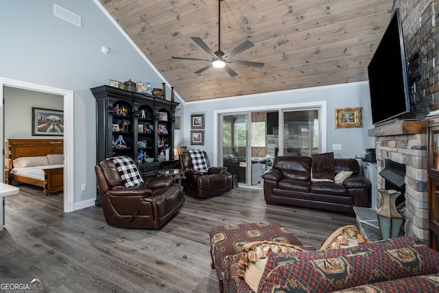 living room featuring wood ceiling, ceiling fan, dark wood-type flooring, high vaulted ceiling, and a stone fireplace