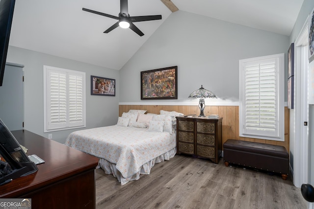 bedroom featuring light wood-type flooring, high vaulted ceiling, and ceiling fan