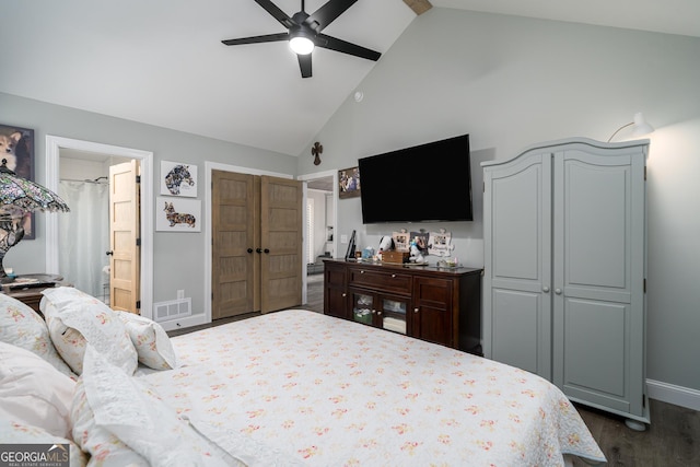 bedroom with dark hardwood / wood-style flooring, high vaulted ceiling, ensuite bath, and ceiling fan