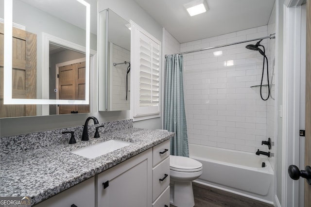 full bathroom featuring vanity, toilet, shower / bath combo with shower curtain, and wood-type flooring