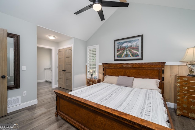 bedroom featuring a closet, ceiling fan, dark hardwood / wood-style flooring, and high vaulted ceiling