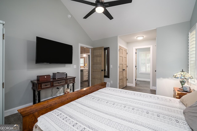 bedroom with hardwood / wood-style flooring, ceiling fan, ensuite bathroom, and high vaulted ceiling