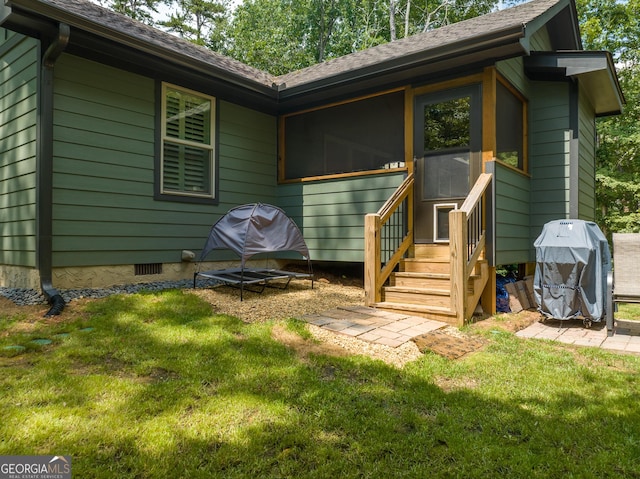 back of property featuring a lawn and a sunroom