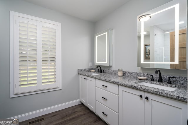 bathroom with vanity and hardwood / wood-style flooring