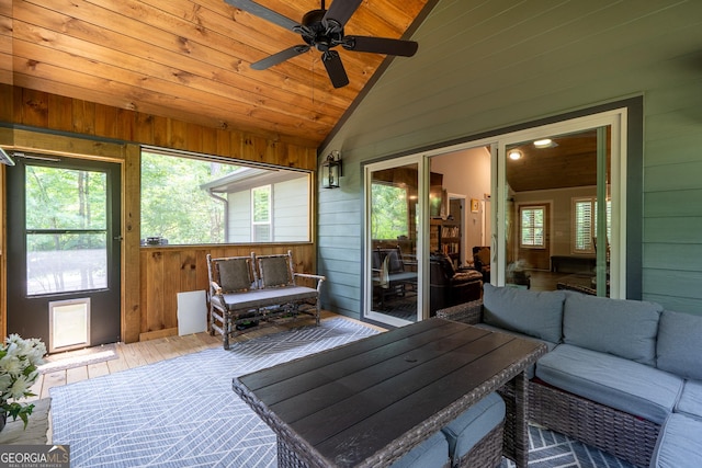 sunroom featuring ceiling fan, wooden ceiling, and lofted ceiling