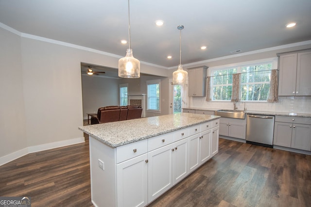 kitchen with pendant lighting, dishwasher, a center island, sink, and dark hardwood / wood-style flooring