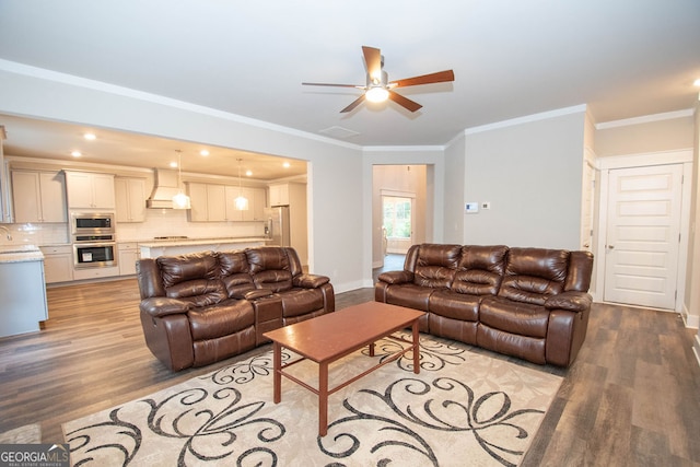 living room with light hardwood / wood-style floors, ceiling fan, crown molding, and sink