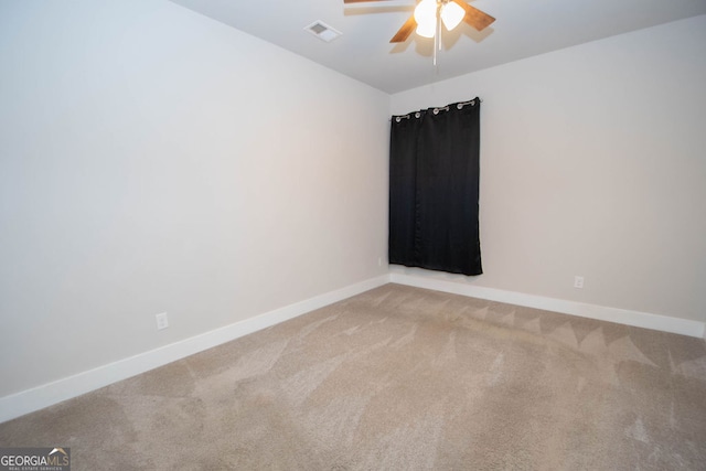 empty room with ceiling fan and carpet floors