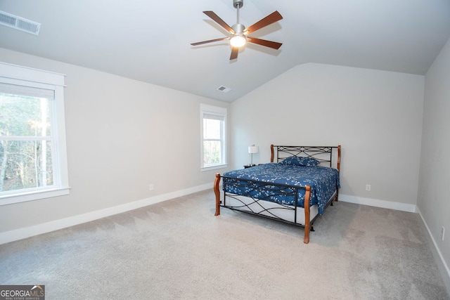 bedroom featuring ceiling fan, lofted ceiling, and light carpet