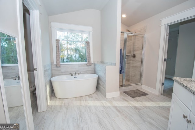 full bathroom with separate shower and tub, toilet, tile walls, and lofted ceiling