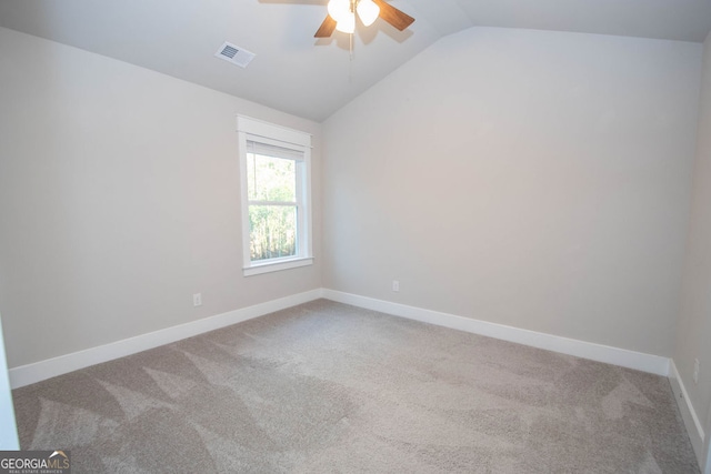 spare room with carpet flooring, ceiling fan, and lofted ceiling