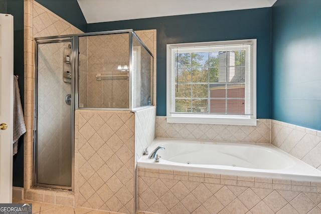 bathroom with tile patterned floors and plus walk in shower