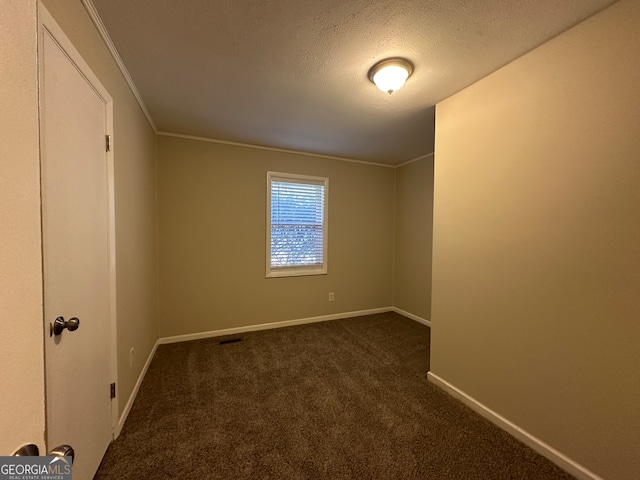 carpeted spare room featuring a textured ceiling and ornamental molding