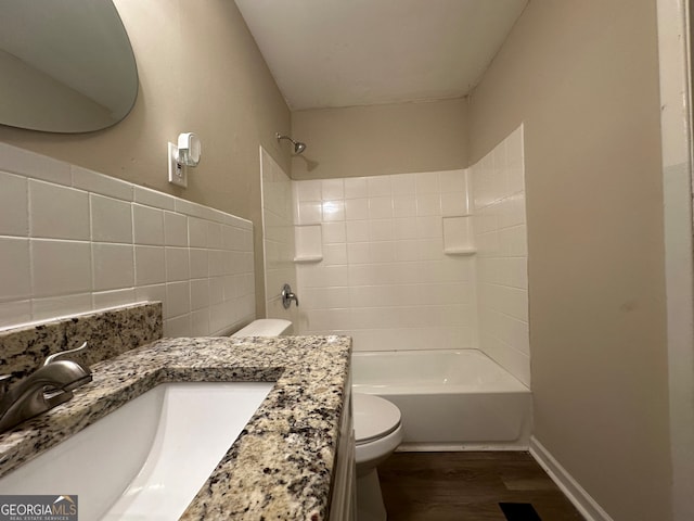 full bathroom featuring vanity, toilet, wood-type flooring, and tiled shower / bath