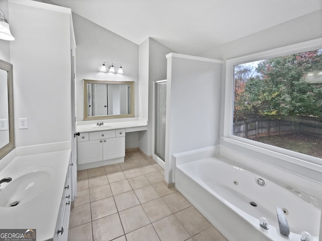 bathroom featuring tile patterned floors, vanity, independent shower and bath, and vaulted ceiling