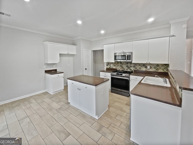 kitchen featuring a center island, sink, white cabinets, and stainless steel appliances